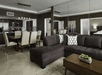 Living area with full kitchen and dining table at DoubleTree by Hilton Grand Hotel Biscayne Bay, FL. 
