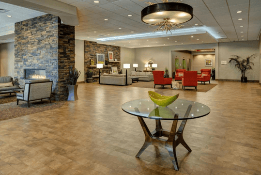 The beautifully decorated lobby of the DoubleTree by Hilton Hotel Flagstaff with two sitting areas and two rock fireplaces.