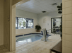 An indoor hot tube with white tile around it and a large window on the wall to the left at the DoubleTree by Hilton Hotel Flagstaff.