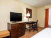 Flat-screen TV and a desk inside a non-smoking room at DoubleTree by Hilton Hotel Grand Rapids Airport, MI.