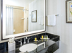 Single vanity with fresh towels and complimentary toiletries.
