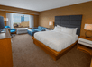 1 King bed, sofa bed, flat-screen TV and work desk inside a guest room at DoubleTree by Hilton Hotel Niagara Falls New York, Niagara Falls, NY. 