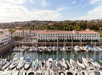 View of the many sailboats in Cabrillo Marina, with the DoubleTree Hotel behind it.