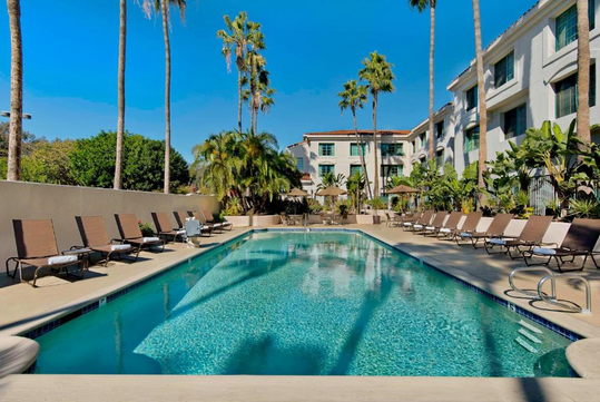 Refreshing outdoor pool with pool lift and sun loungers.
