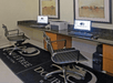 Business center with comfortable chairs and computers.