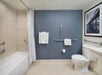 Accessible guest bathroom with fresh towels and a roll-in shower
