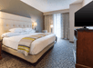 One king bed and a flat-screen TV inside non-smoking room at Drury Inn & Suites Cincinnati Northeast Mason, OH.