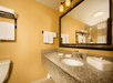 Fresh towels and bathroom amenities inside a private bathroom.
