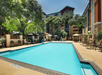 Outdoor pool with sun loungers.
