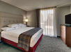 One king bed and a flat-screen TV inside a guest room.