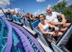 A group of thrill-seekers is savoring the excitement of an exhilarating coaster ride, with some joyfully raising their hands at Dutch Wonderland in Lancaster, Pennsylvania.