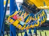 Several children raise their hands in excitement while riding the Merlin’s Mayhem suspension coaster at Dutch Wonderland in Lancaster, Pennsylvania.