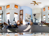 Panoramic view of a home gym with exercise bike, treadmill, weight bench, and mirrors on the walls. Ceiling fan and windows with blinds visible.