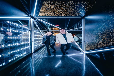 A couple taking the journey down the lighted hallway to Edge New York.