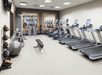 Fitness center with plenty of gym equipment.
