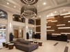 Modern hotel lobby with a large chandelier, contemporary seating, wooden wall accents, and a reception desk.