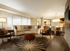 Living area with sofa bed, flat-screen TV and dining table.