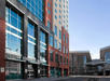 The front exterior of the Embassy Suites by Hilton Denver Downtown Convention Center with lots of windows and red and beige brick.