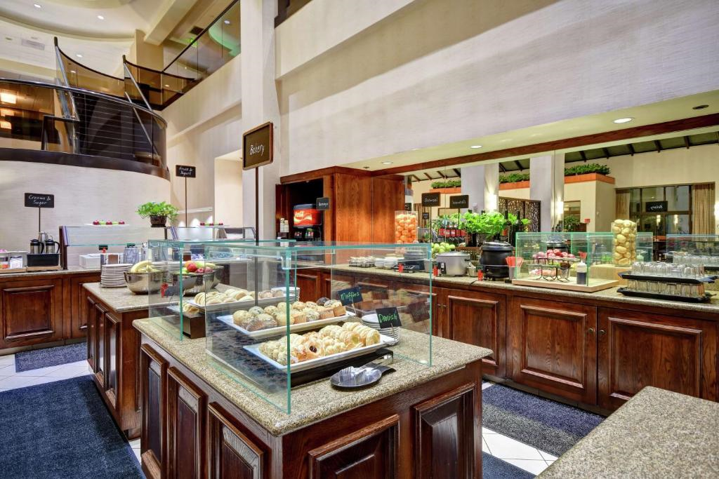 Breakfast area with fresh fruits, oatmeal, breads, and other food items.