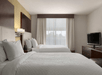 Guest room with 2 queen beds at Embassy Suites by Hilton Savannah Airport, Savannah, GA.