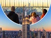 People view New York City from an observation deck; the Empire State Building and city skyline are visible at sunset.