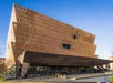 The National Museum of African American History and Culture in Washington, D.C., featuring its distinctive bronze-colored exterior and modern architectural design.