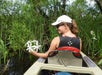 Woman holding flowers while on a kayak in Chokoloskee Island, Florida. 