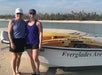 People standing next to an Everglades boat in Chokoloskee Island, Florida.