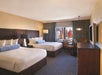 Two queen beds inside a guest room.