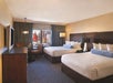 Two queen beds inside a guest room.