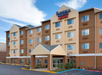 The exterior of a four-story Fairfield Inn & Suites by Marriott hotel with a covered entrance and several windows.