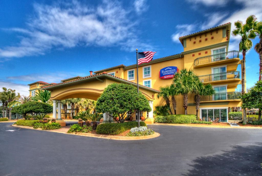Beautifully landscaped entrance to the hotel with the hotel sign.