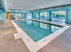 Indoor pool with sun loungers.
