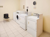 Guest laundry with washing machine and dryers.