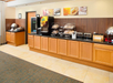 Breakfast area with a variety of breakfast items, toaster, juice machine and more.