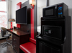 Microwave, flat-screen TV, safe and mini-refrigerator in a guest room.