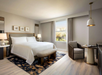 Enjoy a relaxing stay with a king bed, chair, and table.