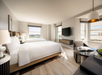Enjoy a cozy stay with two queen beds, a table, and a TV.