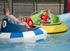 Two people are having fun with water bumper boats.