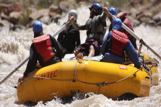 Guests are in awe of the Colorado River while riding their inflatable kayaks.