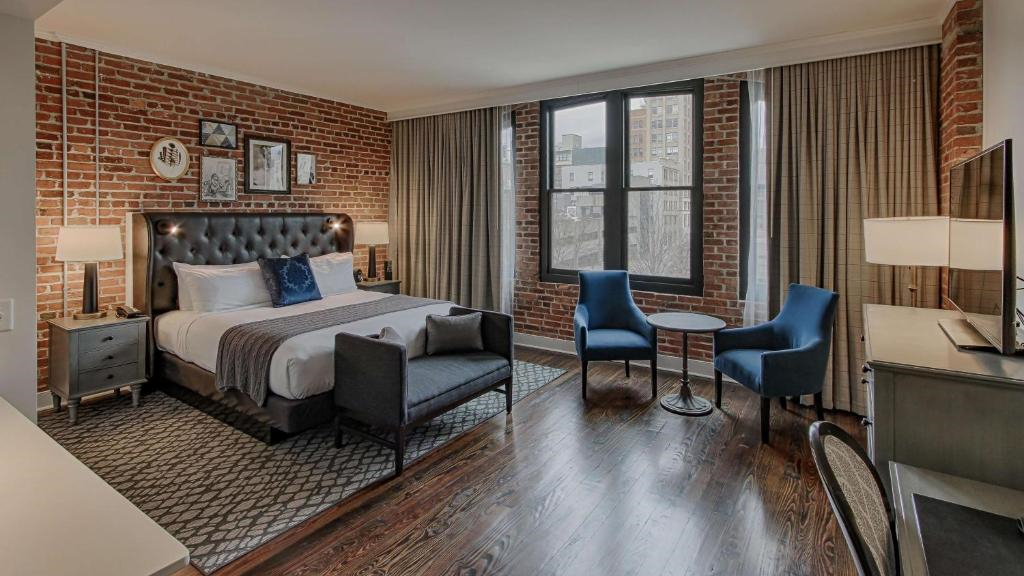 A king bed, footboard bench, and a small table with chairs