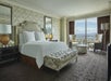 One king bed and seating area inside a guest room with a view.