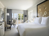 Cozy setting featuring one king bed and a table for two.