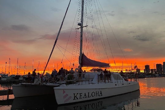 The Kealoha boat is about to set sail and watch the sunset in Waikiki, Hawaii.