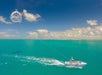 A view of the boat and parasail with passengers in it on the ocean on the Fury Water Adventure Parasailing in Key West, Florida.