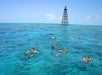 Several tour participants snorkeling in the clear water with Fury Water Adventure in Key West, Florida.