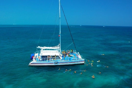 Ariel view of the snorkeling boat with tour participants on the boat and in the water snorkeling with Fury Water Adventure in Key West, Florida.