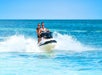 A couple riding a Jet ski on the Fury Water Adventure Ultimate Jet Ski Tour of Key West.