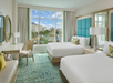 Enjoy comfort and functionality with two queen beds, a desk, and a bright expanded window.