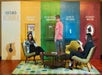A person standing in front of a two of women sitting in chairs at the Chicago History Museum.
